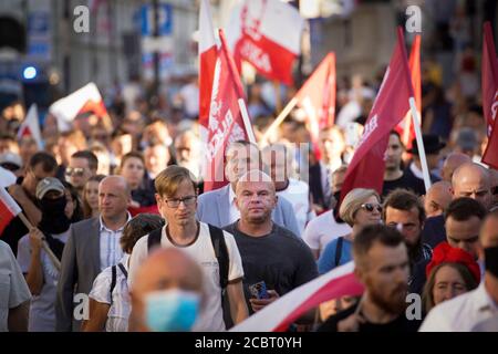 Warsaw, Pl. 15th Aug, 2020. Several hundred people are seen taking part in a march of the ultranaionatlist All Polish Youth (Mlodziez Wszechpolska) in Warsaw, Poland on August 15, 2020. The far-right and ultranationalist youth organisation organized a march on Saturday in light of the 100th anniversary of the Battle of Warsaw, the battle that turned the tide on the Bolshevik invasion of Europe. The All Polish Youth also oppose liberal values and oppose non-binary gender people who they see as a threat to Polish culture. (Photo by Jaap Arriens/Sipa USA) Credit: Sipa USA/Alamy Live News Stock Photo