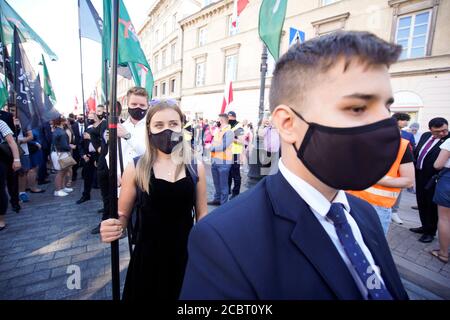 Warsaw, Pl. 15th Aug, 2020. Several hundred people are seen taking part in a march of the ultranaionatlist All Polish Youth (Mlodziez Wszechpolska) in Warsaw, Poland on August 15, 2020. The far-right and ultranationalist youth organisation organized a march on Saturday in light of the 100th anniversary of the Battle of Warsaw, the battle that turned the tide on the Bolshevik invasion of Europe. The All Polish Youth also oppose liberal values and oppose non-binary gender people who they see as a threat to Polish culture. (Photo by Jaap Arriens/Sipa USA) Credit: Sipa USA/Alamy Live News Stock Photo