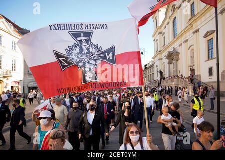 Warsaw, Pl. 15th Aug, 2020. Several hundred people are seen taking part in a march of the ultranaionatlist All Polish Youth (Mlodziez Wszechpolska) in Warsaw, Poland on August 15, 2020. The far-right and ultranationalist youth organisation organized a march on Saturday in light of the 100th anniversary of the Battle of Warsaw, the battle that turned the tide on the Bolshevik invasion of Europe. The All Polish Youth also oppose liberal values and oppose non-binary gender people who they see as a threat to Polish culture. (Photo by Jaap Arriens/Sipa USA) Credit: Sipa USA/Alamy Live News Stock Photo