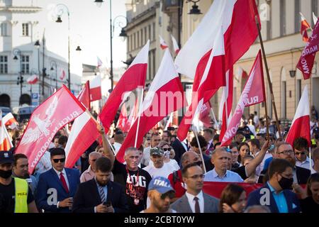 Warsaw, Pl. 15th Aug, 2020. Several hundred people are seen taking part in a march of the ultranaionatlist All Polish Youth (Mlodziez Wszechpolska) in Warsaw, Poland on August 15, 2020. The far-right and ultranationalist youth organisation organized a march on Saturday in light of the 100th anniversary of the Battle of Warsaw, the battle that turned the tide on the Bolshevik invasion of Europe. The All Polish Youth also oppose liberal values and oppose non-binary gender people who they see as a threat to Polish culture. (Photo by Jaap Arriens/Sipa USA) Credit: Sipa USA/Alamy Live News Stock Photo