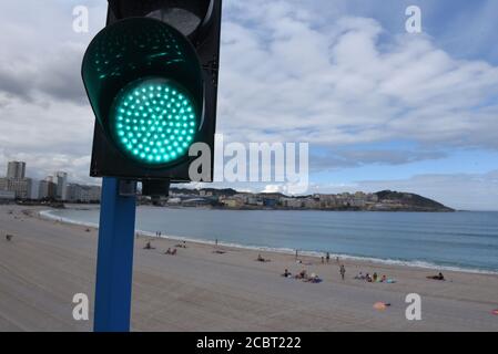 A traffic light system is seen at Orzán beach that allows or prohibits people from entering the beach based on the number of sunbathers already at the beach.The Spanish city A Coruña has recorded 600 new active cases of Coronavirus (Covid-19) after a wide return of the virus in the region. Credit: SOPA Images Limited/Alamy Live News Stock Photo