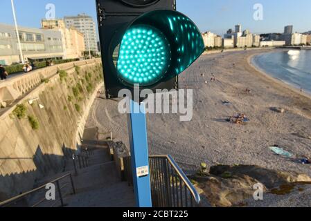 A traffic light system is seen at Orzán beach that allows or prohibits people from entering the beach based on the number of sunbathers already at the beach.The Spanish city A Coruña has recorded 600 new active cases of Coronavirus (Covid-19) after a wide return of the virus in the region. Credit: SOPA Images Limited/Alamy Live News Stock Photo