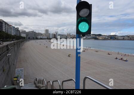 A traffic light system is seen at Orzán beach that allows or prohibits people from entering the beach based on the number of sunbathers already at the beach.The Spanish city A Coruña has recorded 600 new active cases of Coronavirus (Covid-19) after a wide return of the virus in the region. Credit: SOPA Images Limited/Alamy Live News Stock Photo