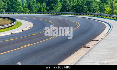 Horizontal shot of the curve in a new city street. Stock Photo