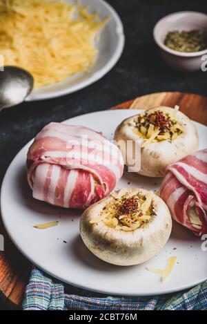 Bacon-wrapped button mushrooms stuffed with cheese Stock Photo