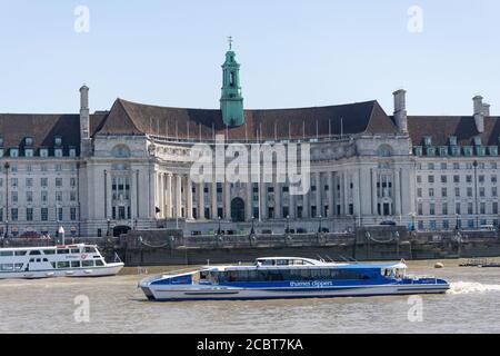 Thames clippers sightseeing boat and London County Hall, South Bank, London Borough of Lambeth, Greater London, England, United Kingdom Stock Photo