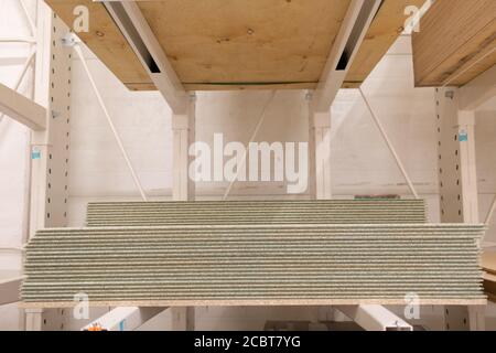 OSB wooden chipboard sheets stacked in store. Stock Photo