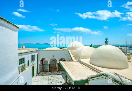 Landscape with traditional architecture and view of seaside in white blue resort town Sidi Bou Said. Tunisia, North Africa Stock Photo