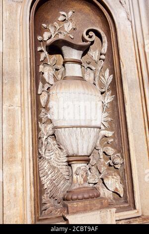 Relief Sculpture of Vase . Carved wall surface Stock Photo