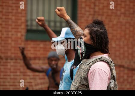 Washington, DC, USA. 15th Aug, 2020. Pictured: two of the leaders of the Defund the Police March walk with raised fists through Georgetown. Credit: Allison C Bailey/Alamy Credit: Allison Bailey/Alamy Live News