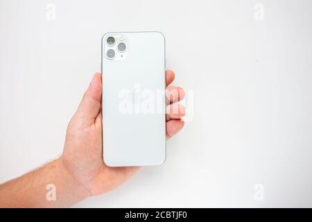 Calgary, Alberta, Canada. Aug 15, 2020. A person holding an iPhone 11 Pro Max on the back side showing the cameras Stock Photo