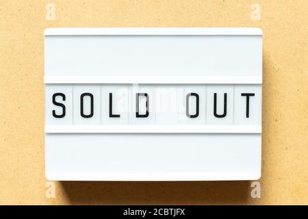 Lightbox with word sold out on wood background Stock Photo