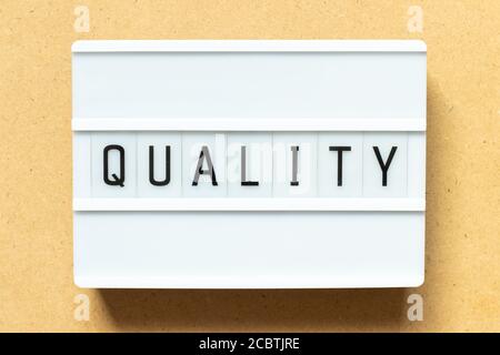 Lightbox with word quality on wood background Stock Photo