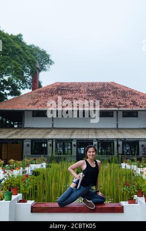 A women practicing yoga on top of Penang Hill, Malaysia. Meditation and balance exercise in beautiful nature mountain landscape. Stock Photo