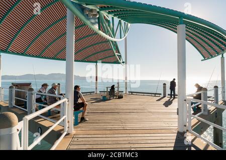 Fishermen in the morning on a warm winter's day on the Strand jetty, Townsville, Australia Stock Photo