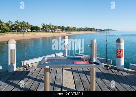 Popular fishing spot with fish cleaning station on the jetty at The Strand, Townsville, Australia Stock Photo