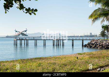 Fishermen in the morning on a warm winter's day on the Strand jetty, Townsville with the port behind Stock Photo