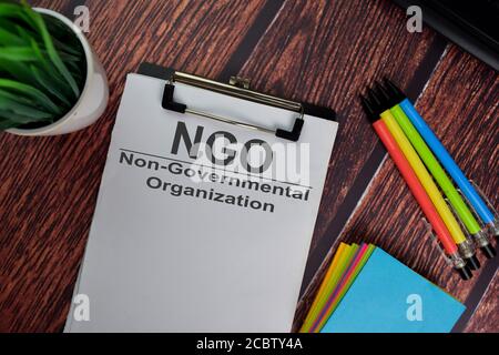 NGO - Non-Governmental Organization text write on a paperwork isolated on office desk. Stock Photo