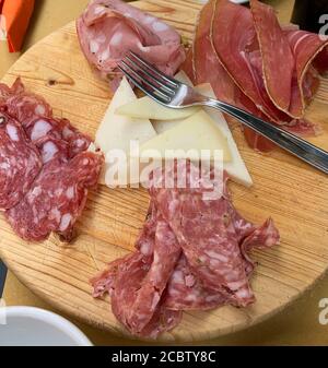 Concept of italian food. Platter of Tuscan cold cuts and cheeses. Closeup. Stock Photo