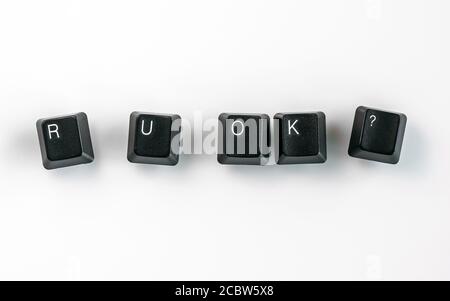 Computer keyboard keys spelling R U OK?, isolated on white background Stock Photo