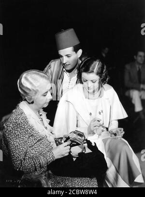 LOUISE CLOSSER HALE RAMON NOVARRO and MYRNA LOY on set candid during filming of THE BARBARIAN aka A NIGHT IN CAIRO 1933 director SAM WOOD from the play The Arab by Edgar Selwyn Metro Goldwyn Mayer Stock Photo