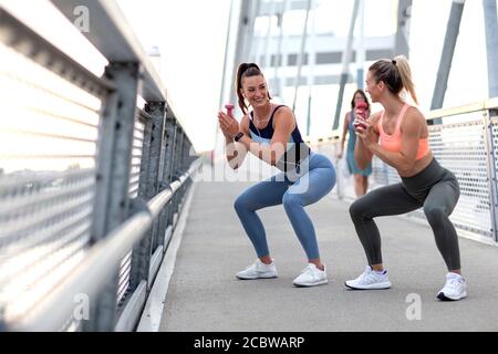 Young fit good looking couple woman stretching outside Stock Photo