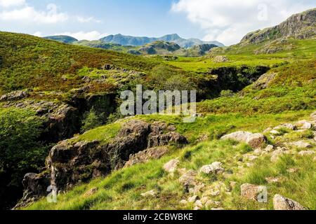 The Upper Esk valley with the Scafell mountains in the distance, Lake District National Park Stock Photo