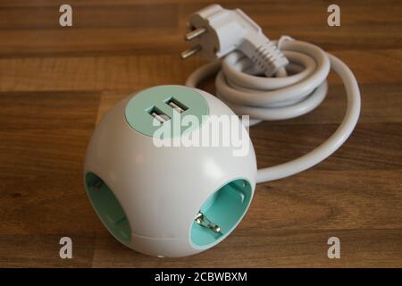 An Extension Socket with USB Port for charging phones and electronic devices, white power cord. Stock Photo