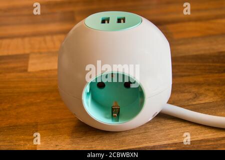 An Extension Socket with USB Port for charging phones and electronic devices, white power cord. Stock Photo