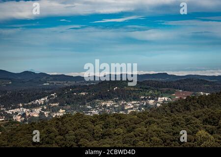 city view with mountain range and bright blue sky from hill top at day image is taken from doddabetta peak ooty india. it is showing the bird eye view Stock Photo