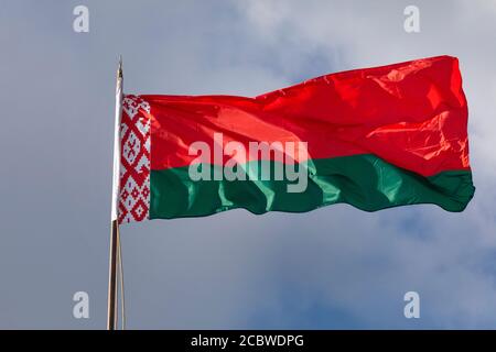 Close-up view of the national flag of the Republic of Belarus fluttering in the wind against the sky on a sunny day Stock Photo