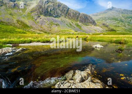 The River Esk flowing across Great Moss below Sca Fell, Lake District National Park. Stock Photo