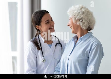 Caring millennial nurse helping middle aged patient at meeting. Stock Photo