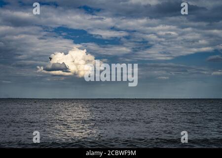 Lonely cloud above sea Stock Photo