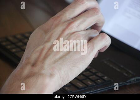 Close-up of hand typing on laptop keyboard. Online business concept Stock Photo