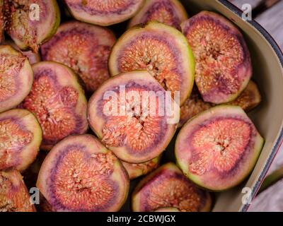 A roasting tray of halved home-grown figs in a country garden in south-east UK, August. Stock Photo