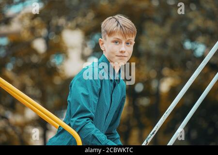 young man on a swing in the park Stock Photo