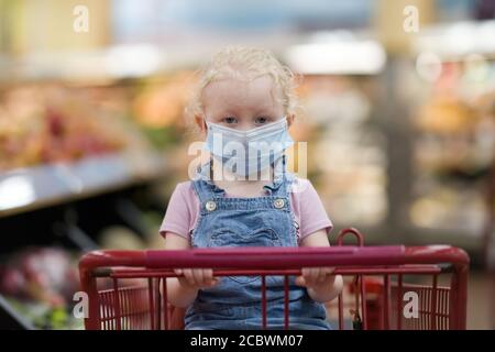 Child wearing medical protective mask on his face during corona virus. Stock Photo