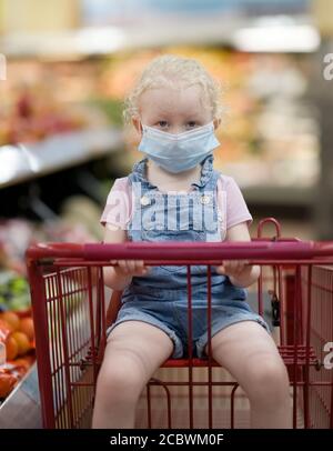 Child wearing medical protective mask on his face during corona virus. Stock Photo