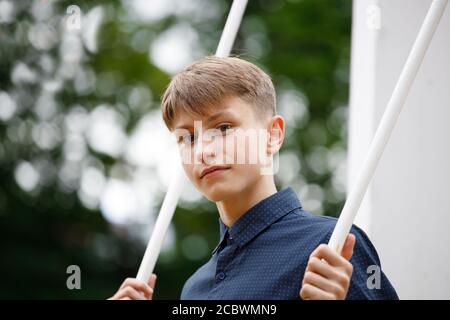 young man on a swing in the park Stock Photo