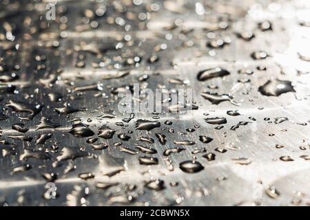 water drops on a shiny metal surface. background. Stock Photo