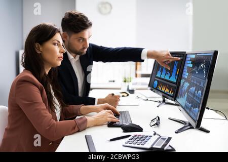 Financial Advisor And Business Analyst Working On Computer Stock Photo