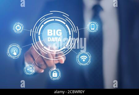 Businessman pushing with Big Data button with computer pictograms, creative collage Stock Photo