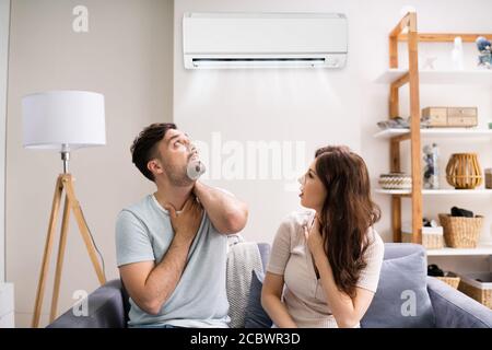 Sick Couple Having Cold And Sore Throat From Air Conditioner Stock Photo