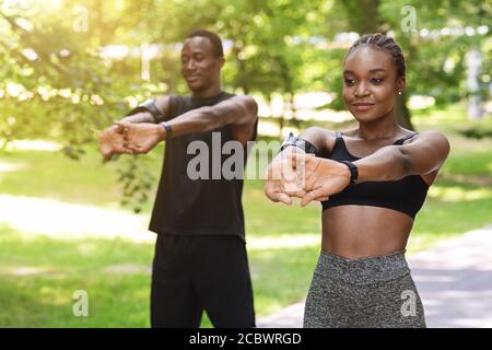 Healthy Lifestyle Concept. Black millennial couple doing sport outdoors together Stock Photo