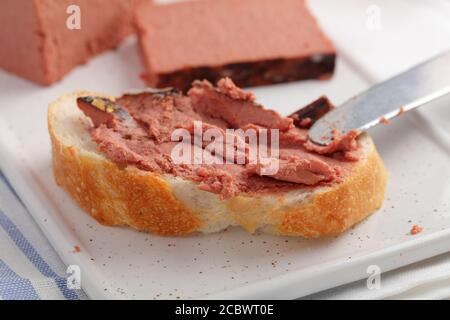 Sandwich with duck pate on a slice of fresh French baguette Stock Photo