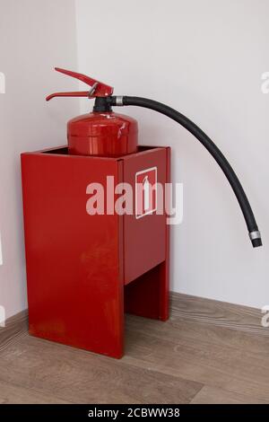 Dry chemical powder fire extinguisher in corridor Stock Photo