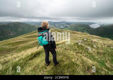 Lady hiker admiring the view of Ullswater from Beda Fell in the Lake District, Cumbria Stock Photo