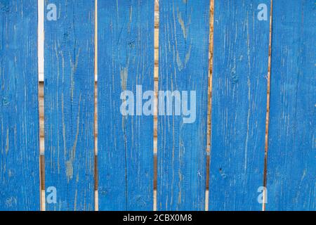 Old rustic wooden fence with shabby blue paint. Stock Photo