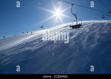 Chair lift, on a bright winter day in the village of Sheregesh, top Green Stock Photo
